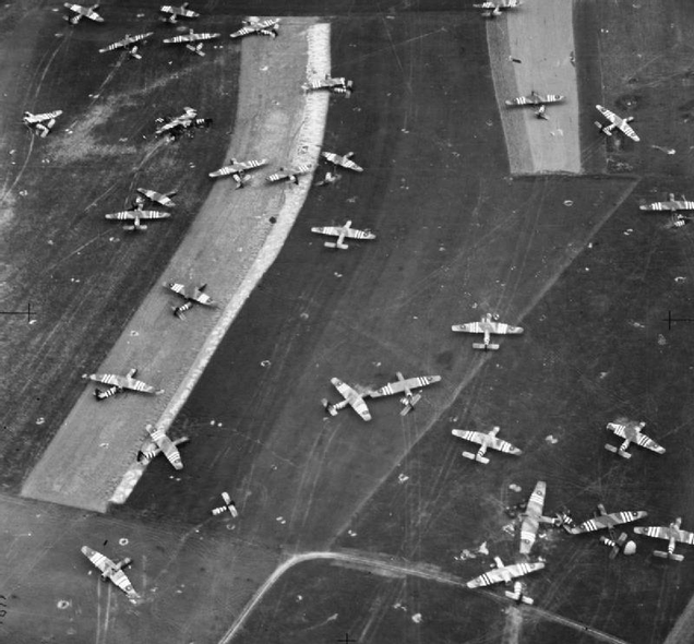 Taken on June 7, or D-Day plus one, British gliders, painted with black and white recognition stripes, lie strewn around Landing Zone N north of Ranville, Normandy. These gliders transported the 6th Airlanding Brigade and the Airborne Armoured Reconnaissance Regiment during Operation Mallard. (Imperial War Museum)